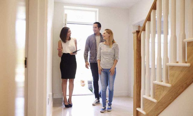 An real estate agent talking to a couple.