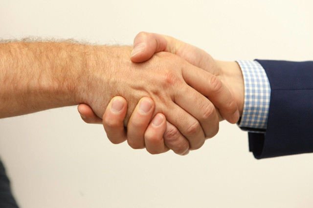 A handshake between 2 people.