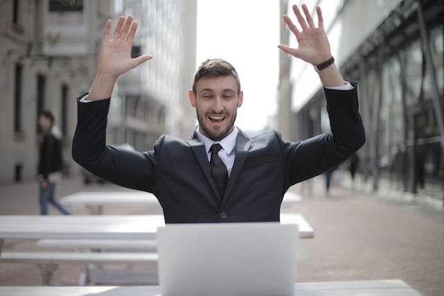 A man celebrating with arms up.