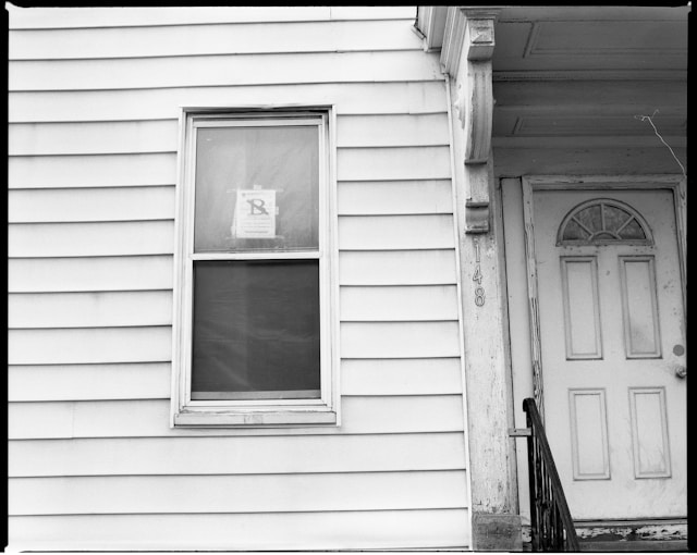 A house with a foreclosed sign on the window.