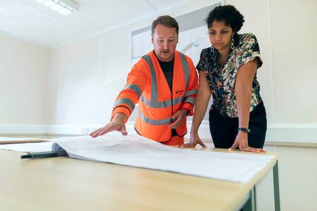 A land developer talking to a real estate agent.