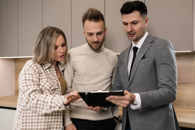 A real estate agent explaining something on an iPad.