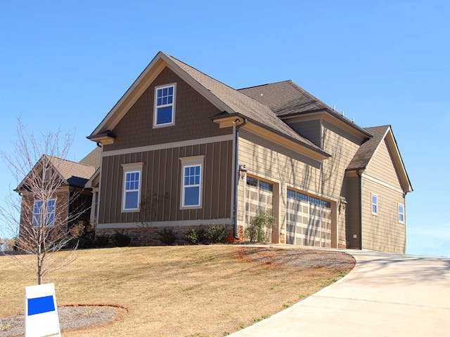 A brown house on a hill.