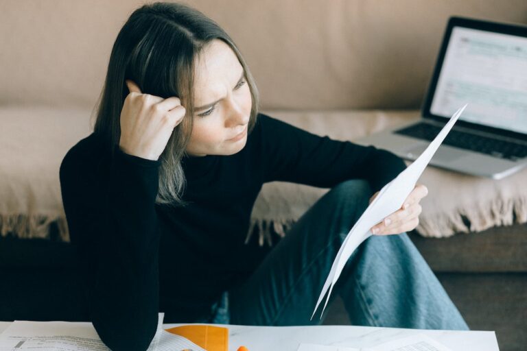 Woman evaluating the paper she's holding
