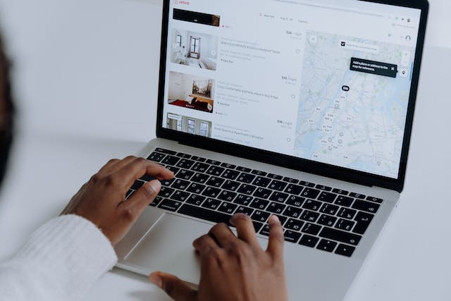 A person looking through Airbnb listings on their laptop.